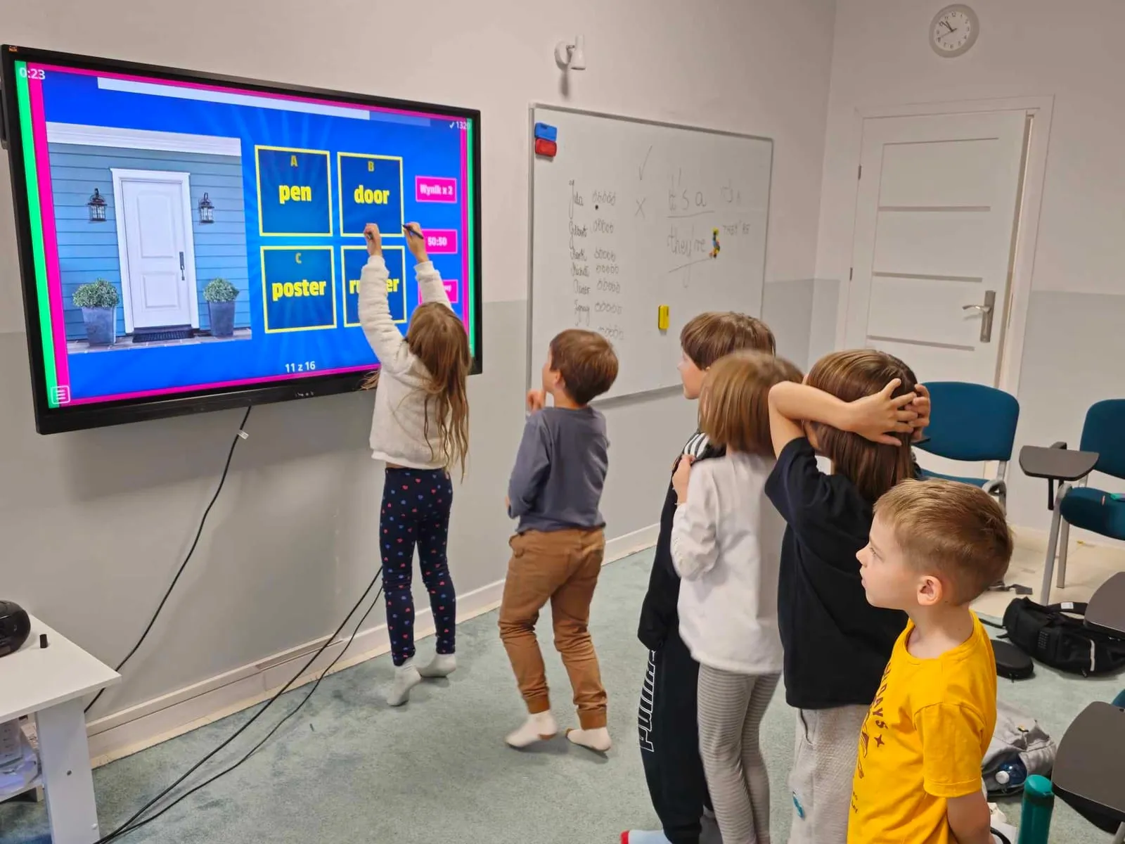 Students at an interactive whiteboard during a lesson